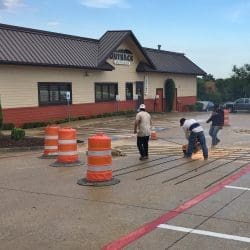 Worker Cutting Metal Stakes for Commercial Parking Lot Concrete Repair in DeSoto, TX