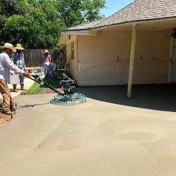 Workers Buffing Concrete for Residential Patio
